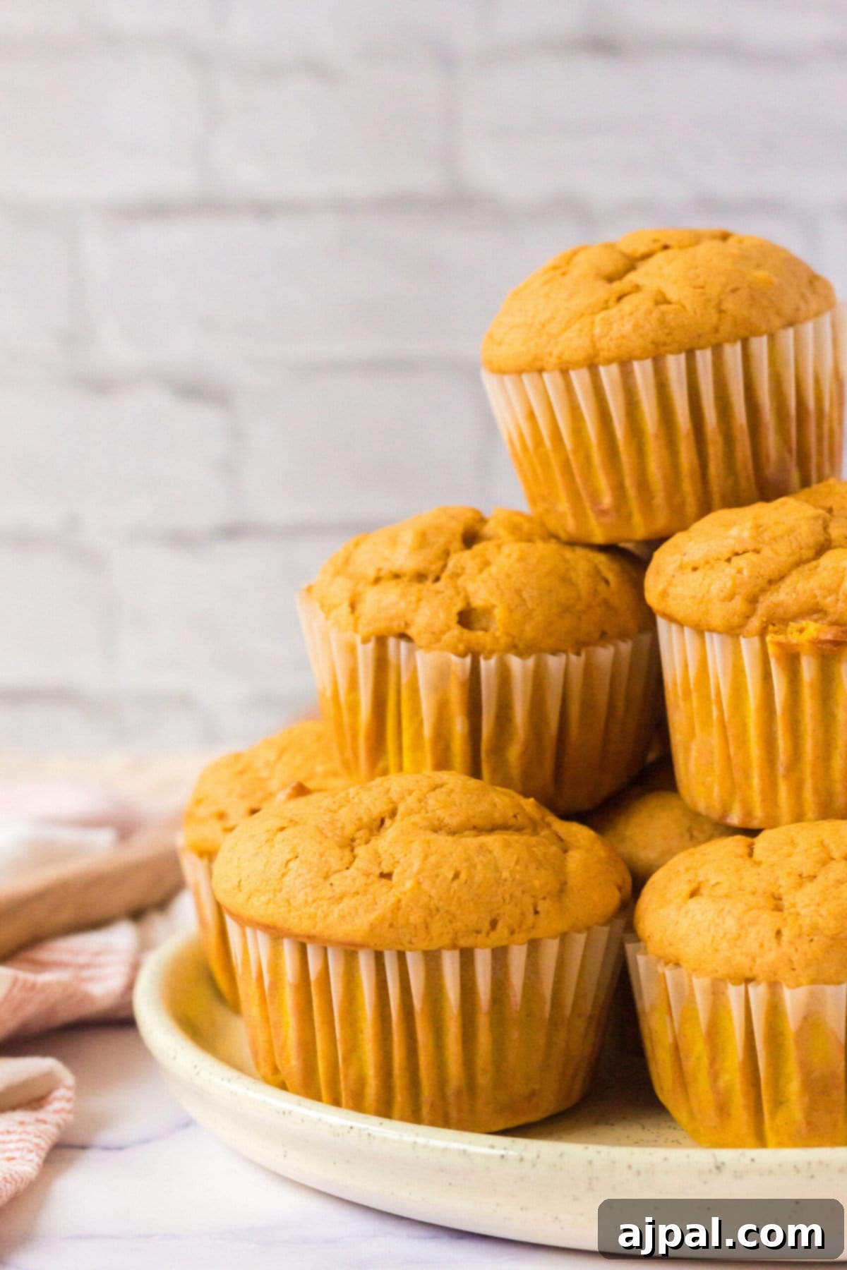 picture of pumpkin spice muffins stacked on a table