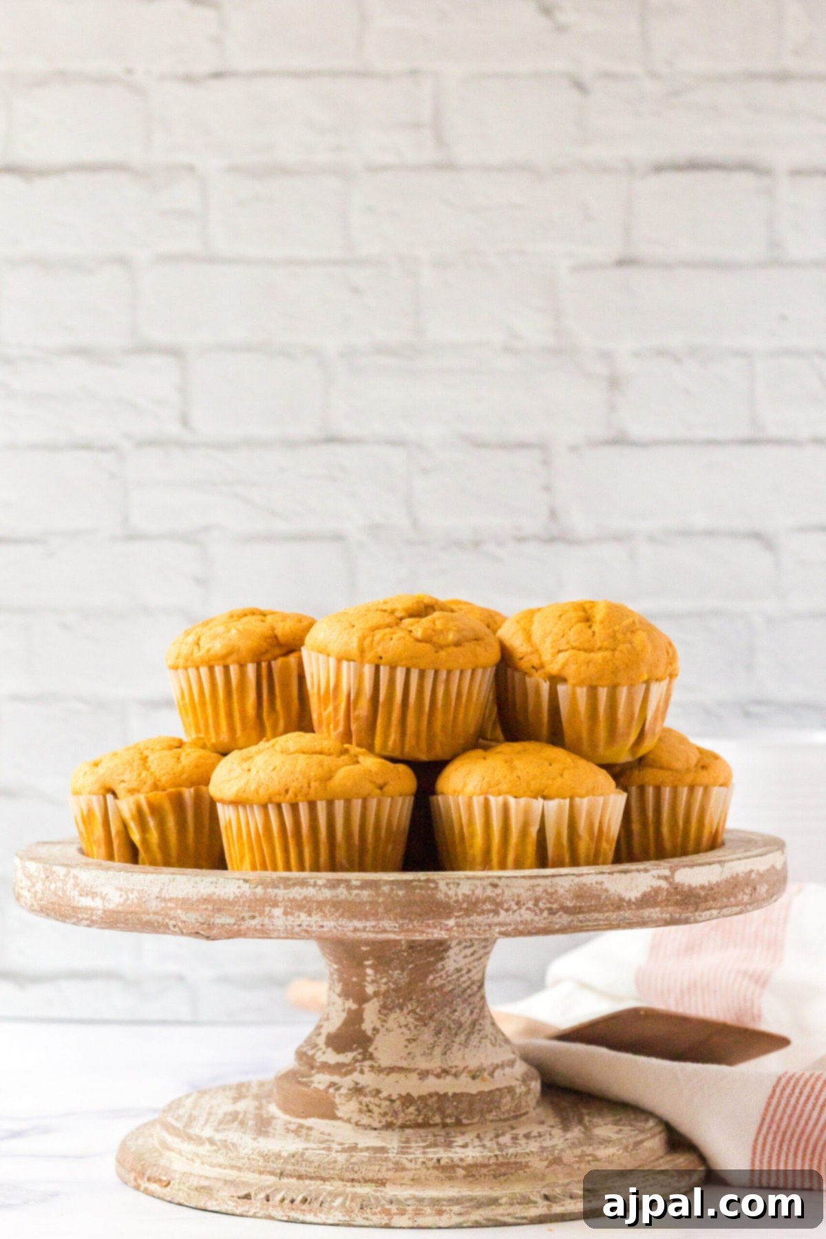 picture of pumpkin spice muffins stacked on a table