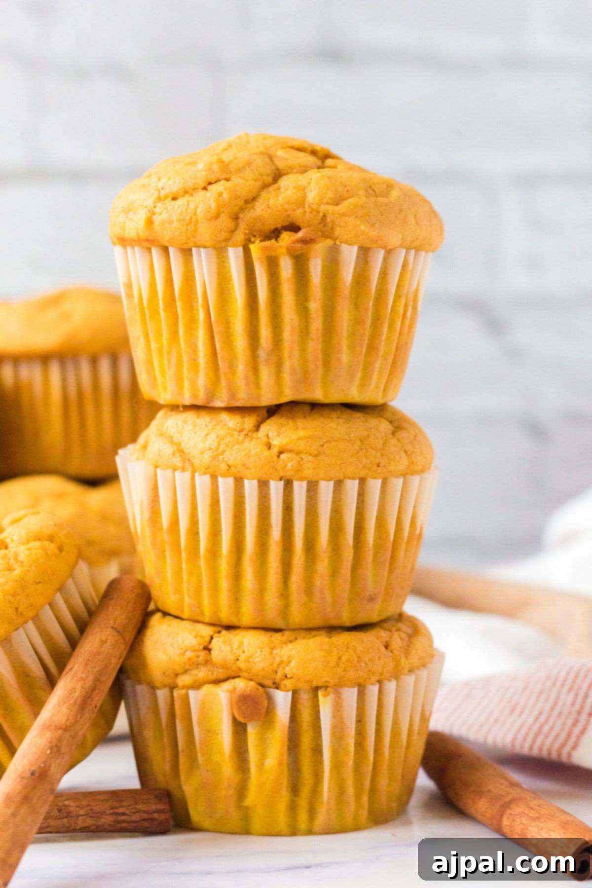 picture of pumpkin spice muffins stacked on a table