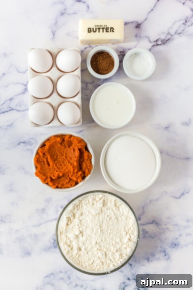 picture of pumpkin, flour, eggs, butter, milk, spices on a table