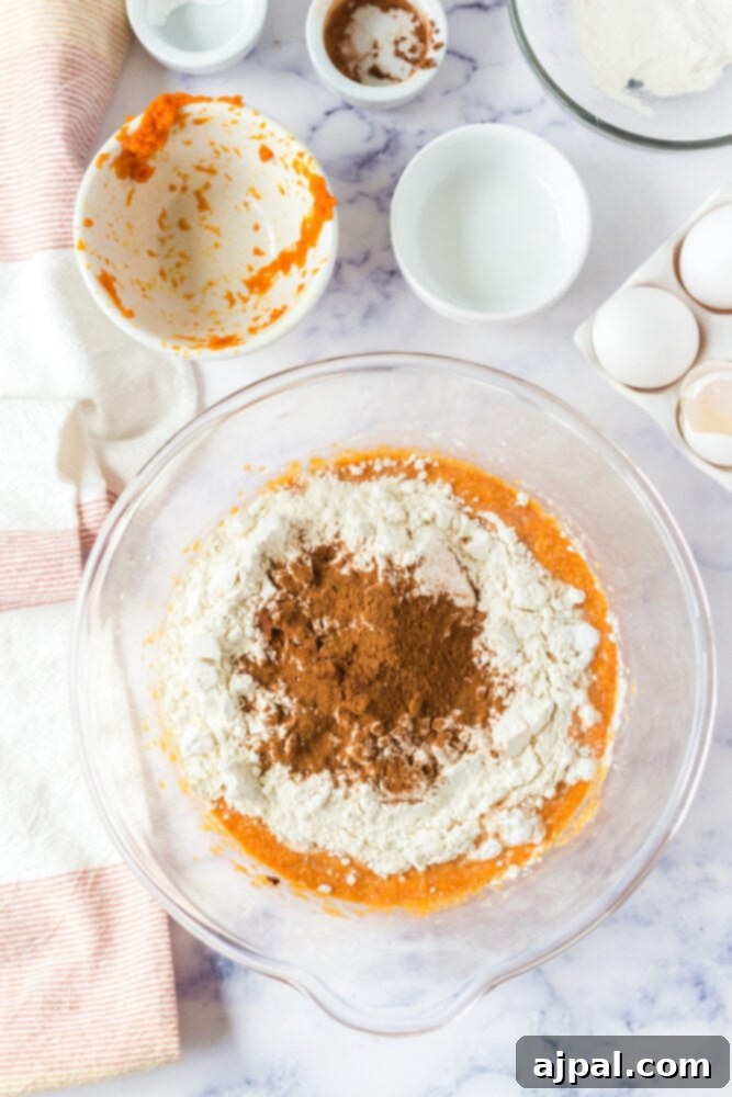 picture of pumpkin muffin batter being mixed in a bowl
