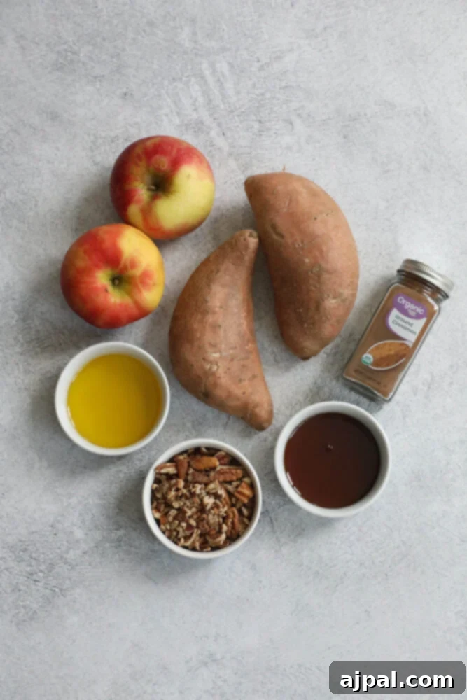 Selection of raw ingredients for the bake: apples, sweet potatoes, olive oil, cinnamon, pecans, and maple syrup.
