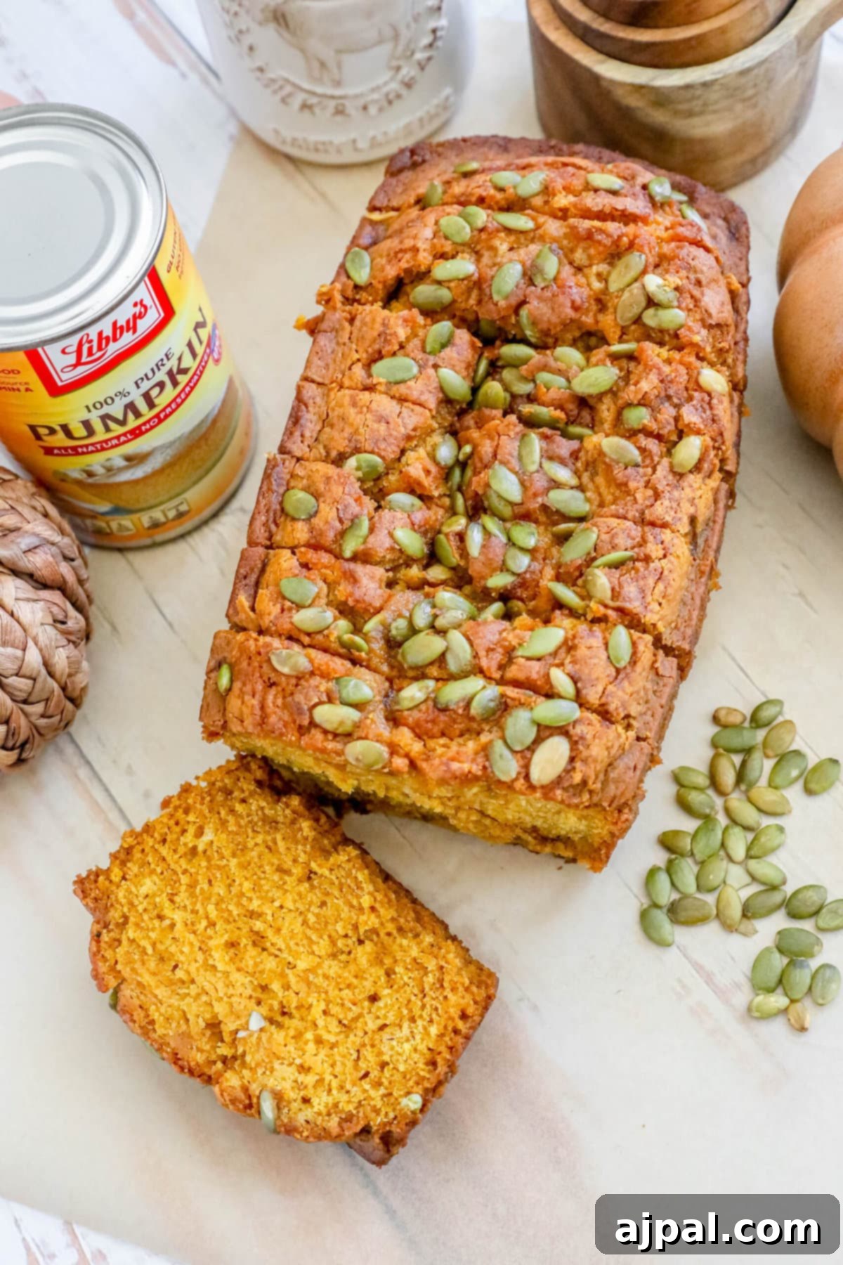 Starbucks-Inspired Pumpkin Bread 9 Copycat Starbucks Pumpkin Bread with pumpkin seeds on a cutting board.