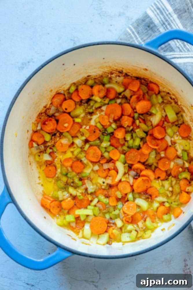 Smoked Ham and Bean Stew 7 picture of browned carrots, celery, garlic, and onions in a dutch oven