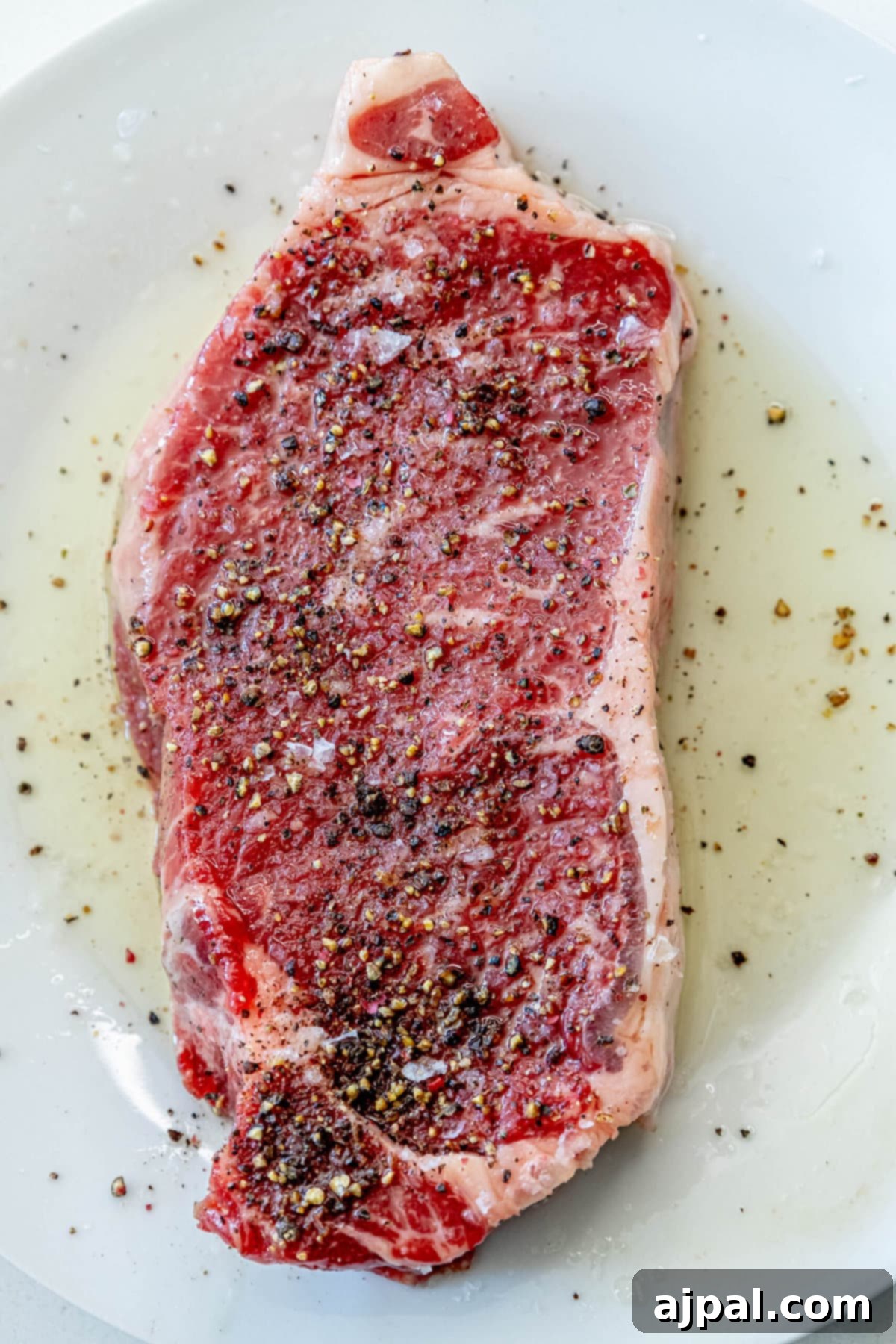 picture of a steak marinating in oil and spices