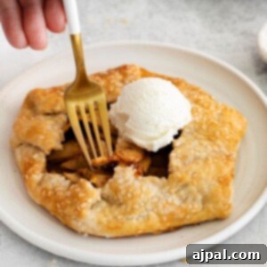 A homemade apple galette served with a scoop of ice cream.