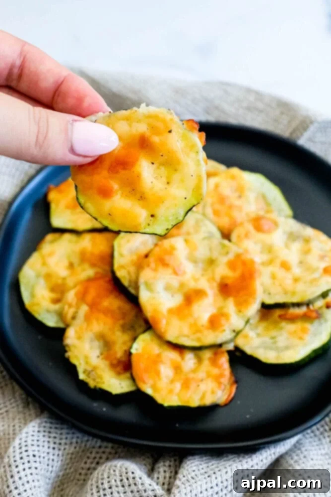 Parmesan Crusted Zucchini 4 Baked Parmesan zucchini chips on a black plate.