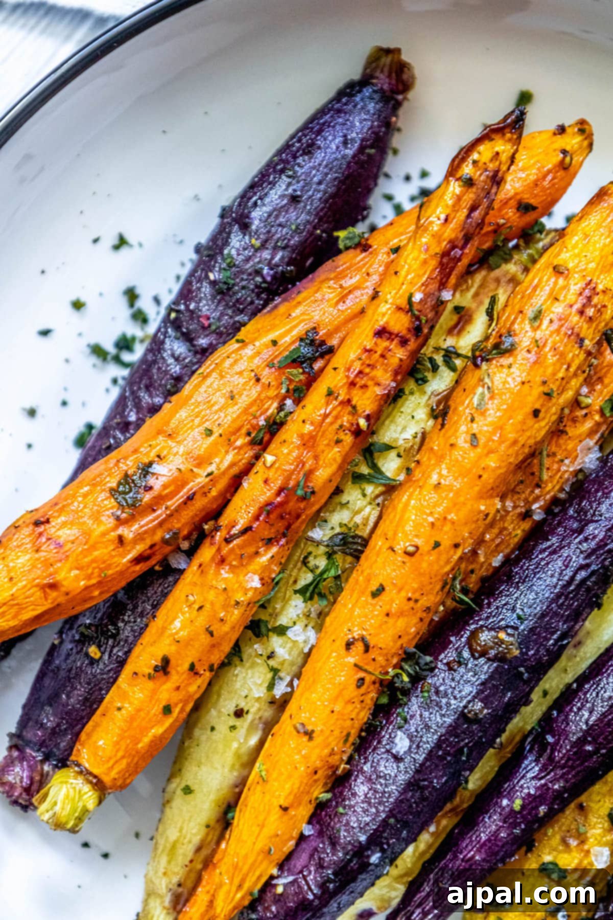 Herbed grilled carrots on a plate.