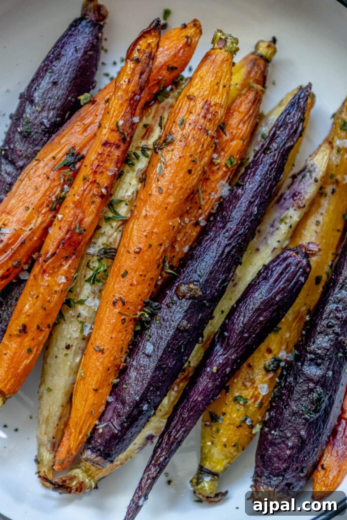 Roasted carrots on a plate with herbs: grilled carrots recipe with easy herbed flavor.