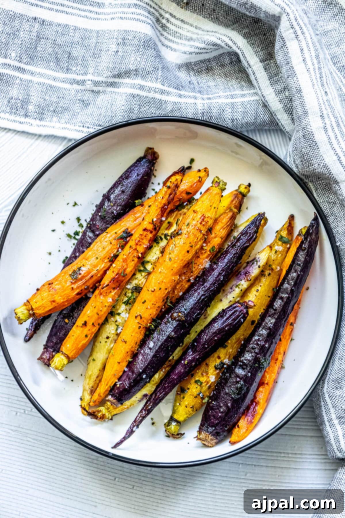 Easy grilled carrots on a white plate.
