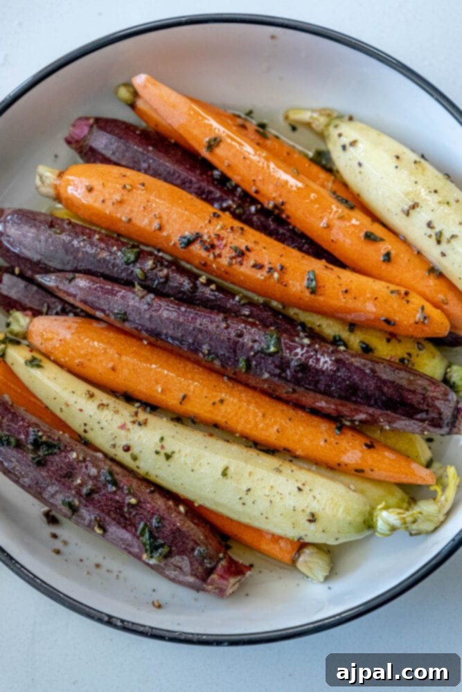 Grilled carrots on a plate with herbs.