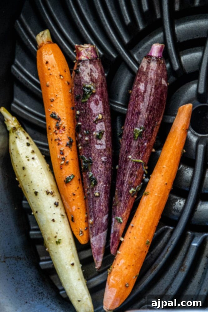 Grilled carrots in a black frying pan.