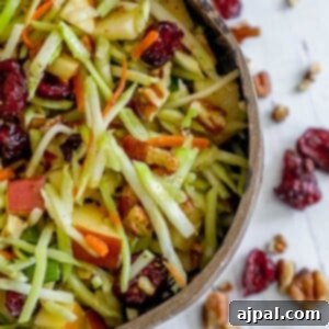 picture of cranberry slaw salad with pecans in a brown bowl on a table