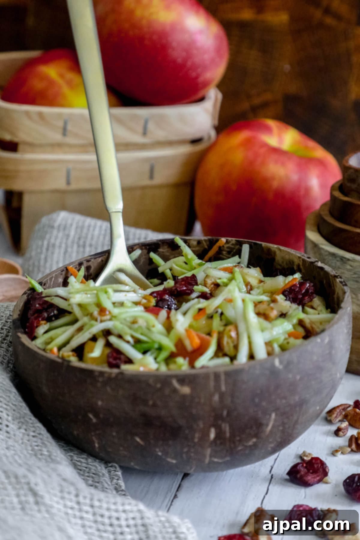 Sweet and Crunchy Cranberry Pecan Salad 3 Cranberry pecan slaw with apples and cranberries in a wooden bowl.