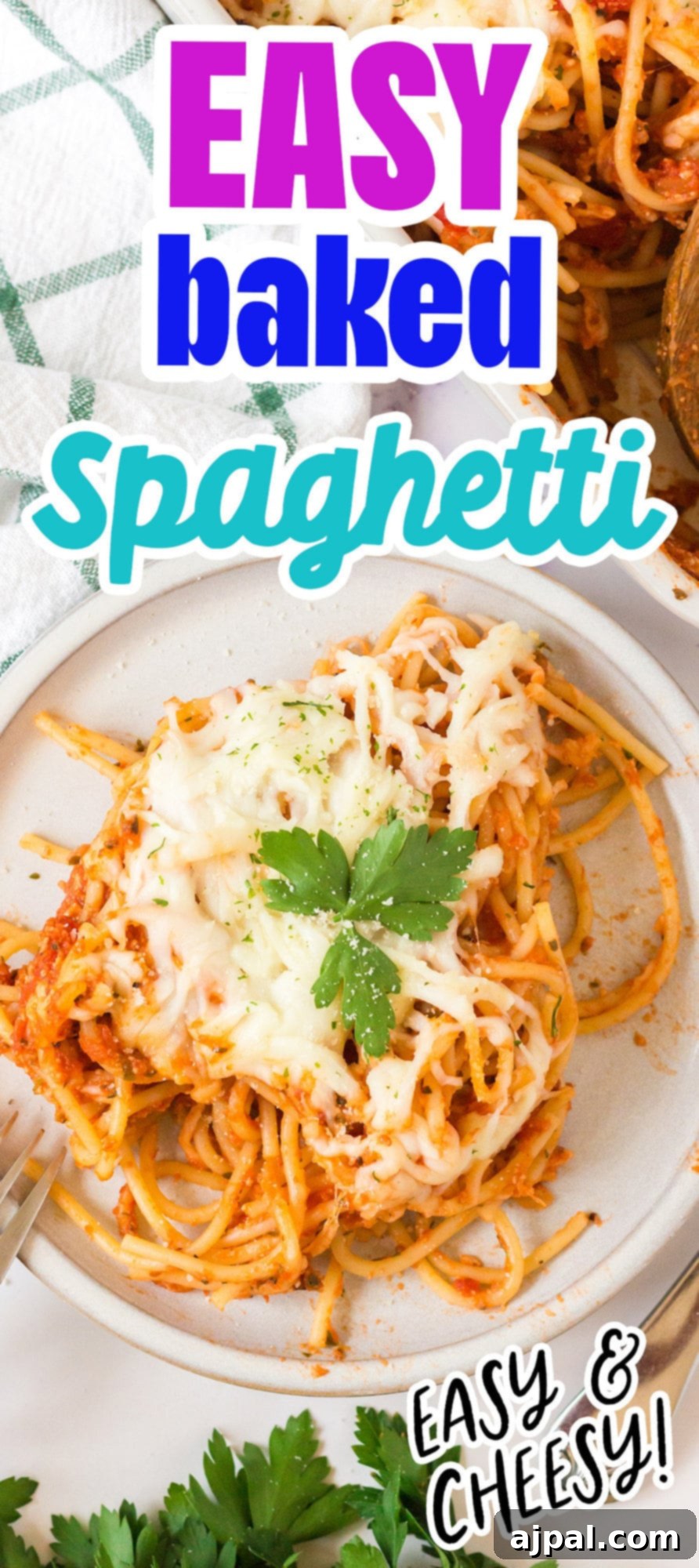 Ultimate Cheesy Spaghetti Bake 12 picture of baked spaghetti with melted cheese on a plate topped with basil with forks next to it