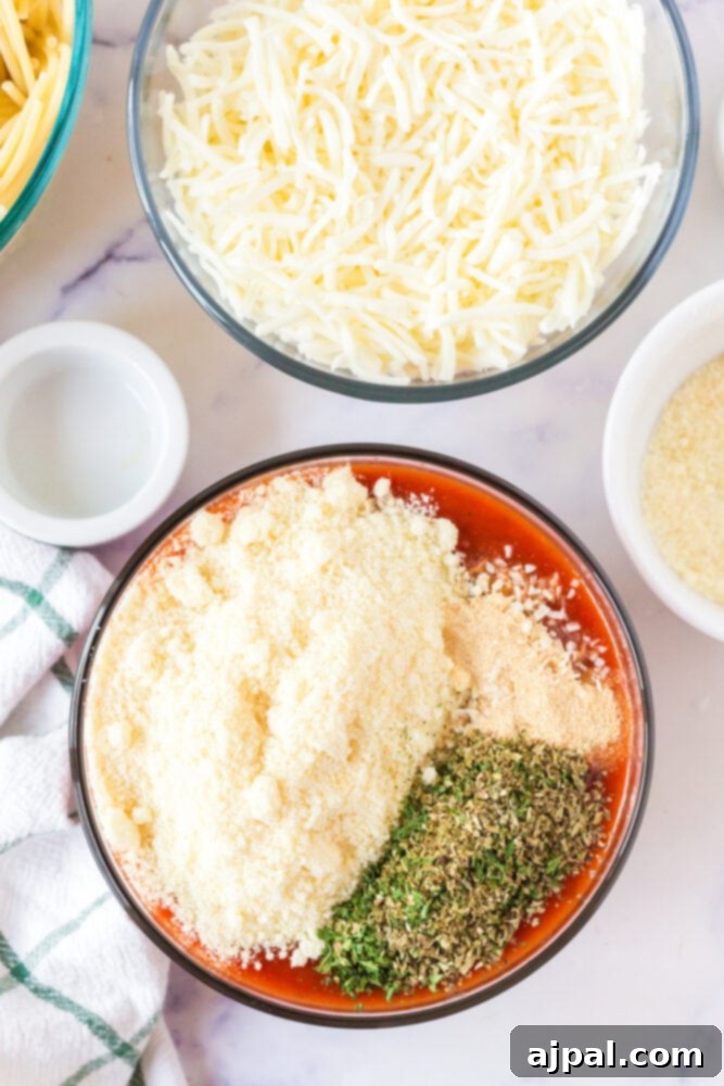 Ultimate Cheesy Spaghetti Bake 6 picture of cheese and pasta in a bowl being mixed