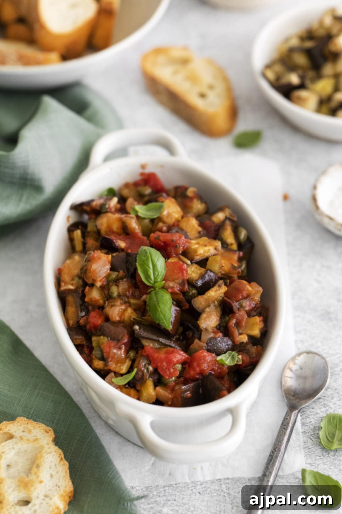 No-Fuss Eggplant Caponata 13 A vibrant vegan eggplant caponata, served attractively with crusty bread and crisp breadsticks.