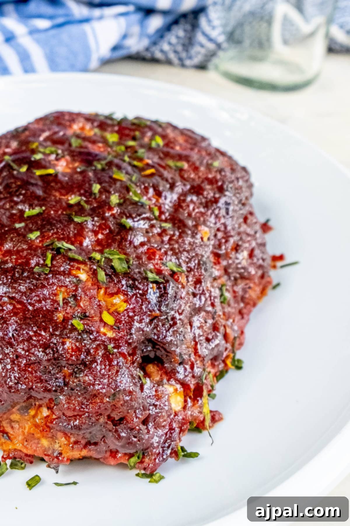 Up close view of the deliciously crusted exterior of smoked meatloaf, showcasing its smoky bark.