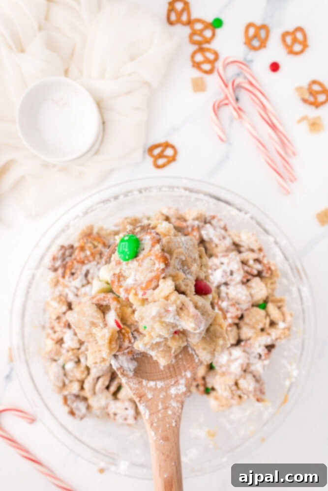 picture of chex mix tossed with christmas candy and powdered sugar