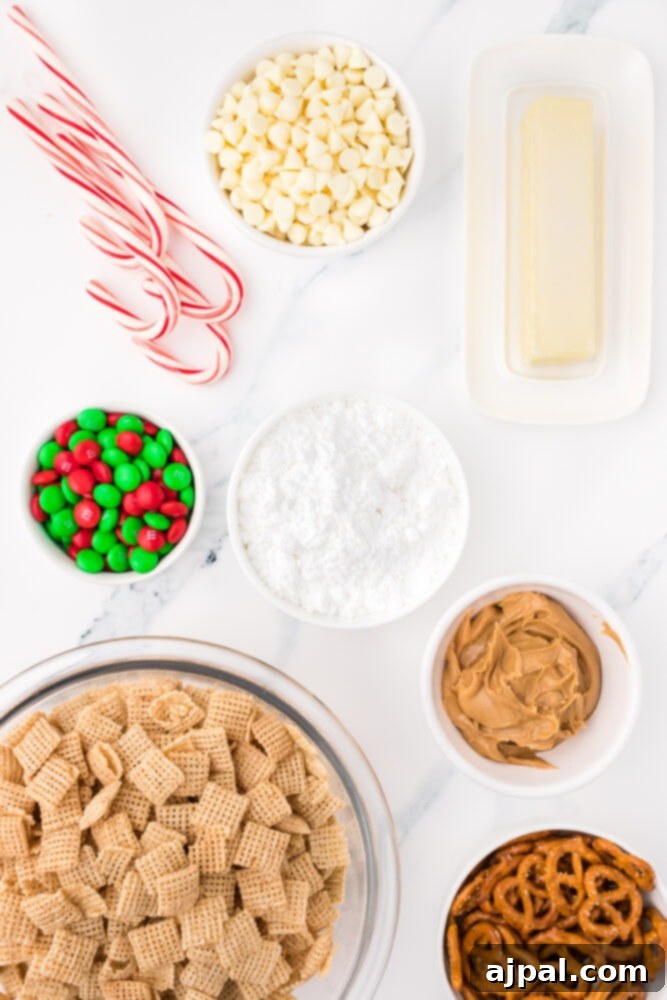 picture of chex, pretzels, powdered sugar, peanut butter, butter, white chocolate chips, and christmas candy on a table