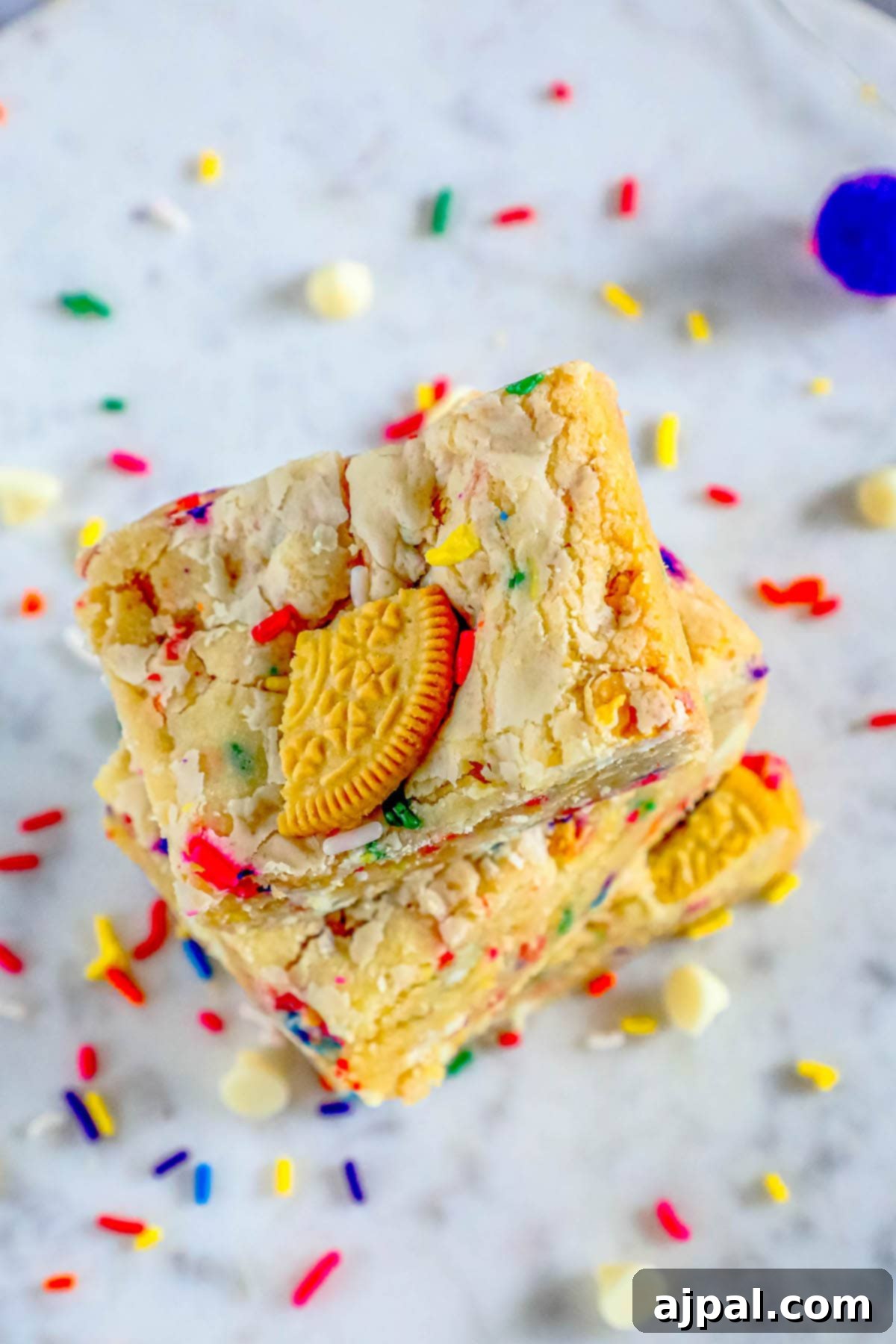 Chewy Funfetti Cookie Bars 11 Close-up of baked funfetti cookie bars topped with broken Oreos and sprinkles.