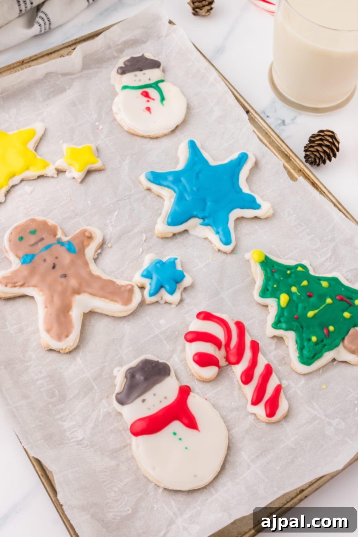 Simple Frosted Christmas Sugar Cookies 2 picture of iced christmas cookies on a white plate on a table