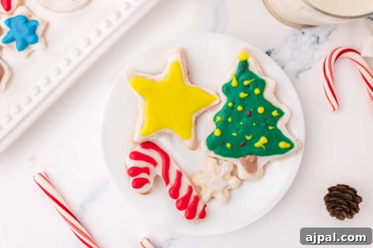Simple Frosted Christmas Sugar Cookies 15 picture of iced christmas cookies on a white plate on a table