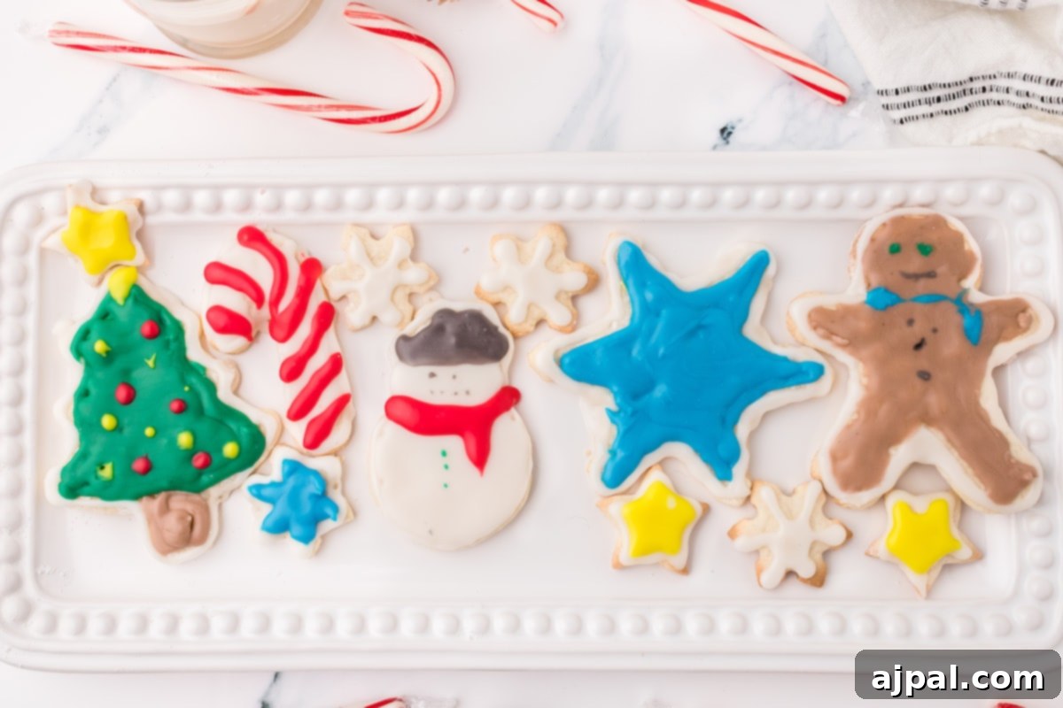 Simple Frosted Christmas Sugar Cookies 3 picture of iced christmas cookies on a white plate on a table