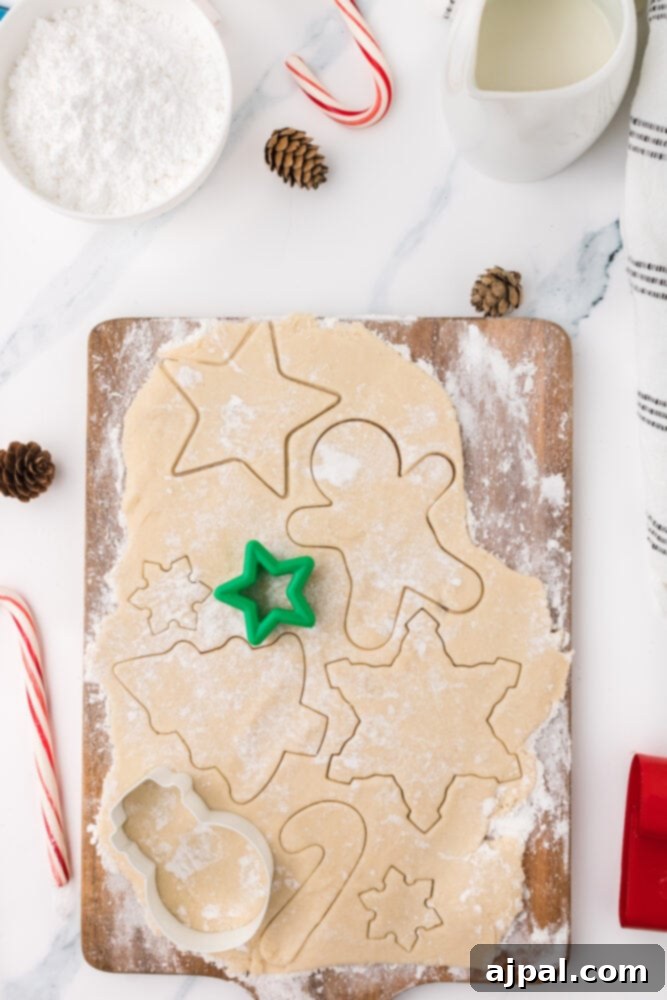 Simple Frosted Christmas Sugar Cookies 8 picture of sugar cookies being cut out on a cutting board