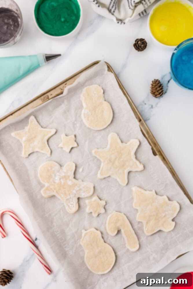 Simple Frosted Christmas Sugar Cookies 9 picture of sugar cookies baking on baking sheet lined with parchment paper