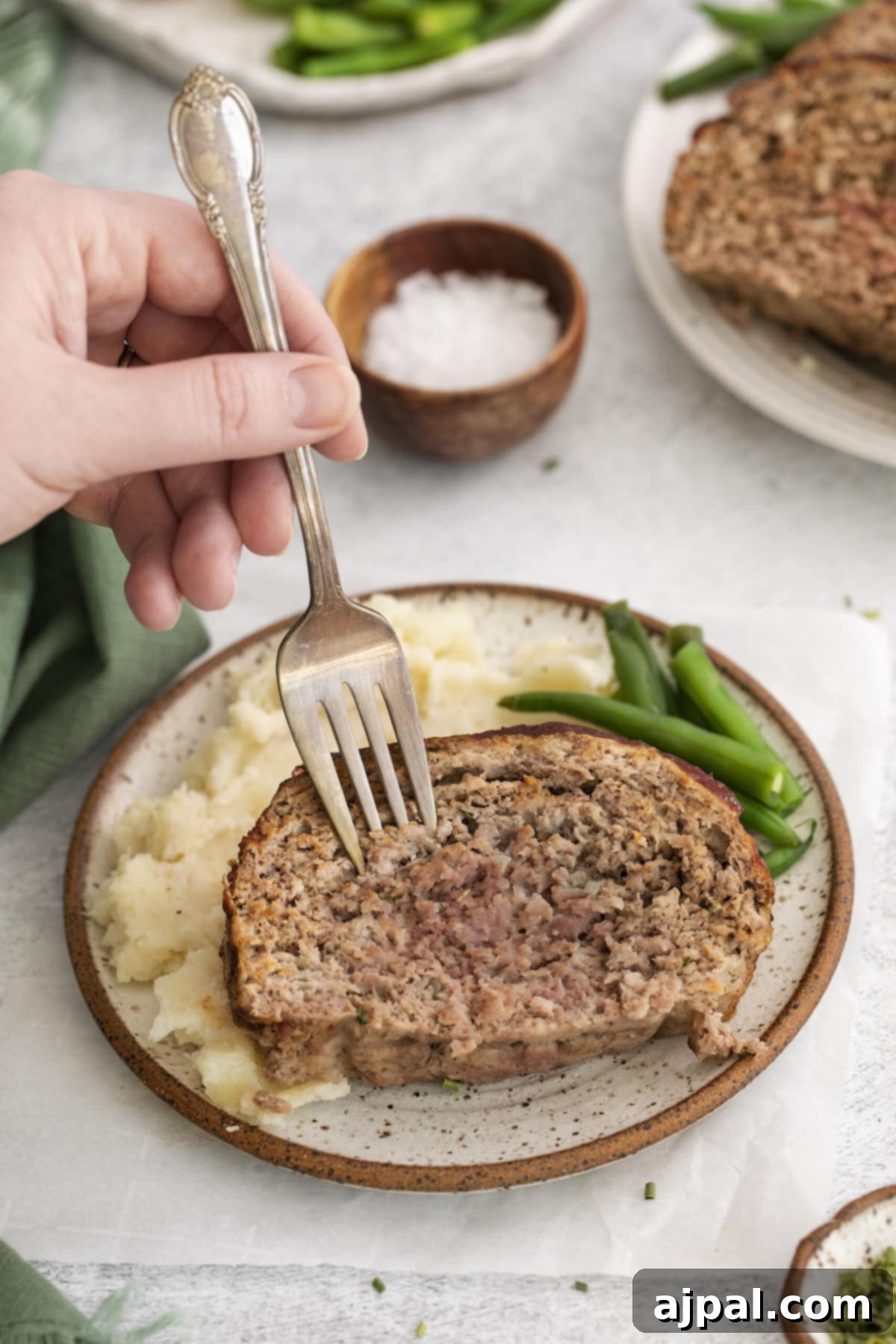 fork in meatloaf with green beans