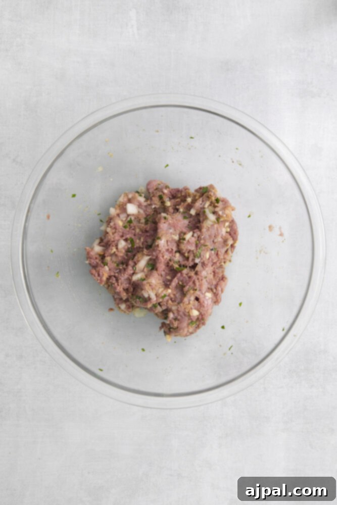 A plate with air fried meatloaf on a white background.