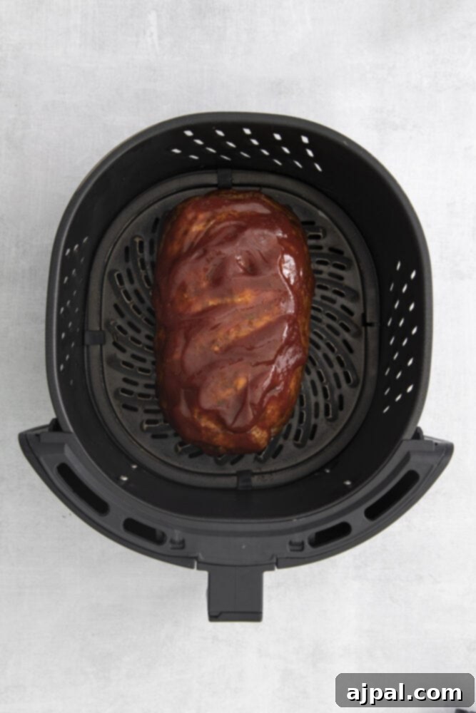 An air fryer cooking a meatloaf.