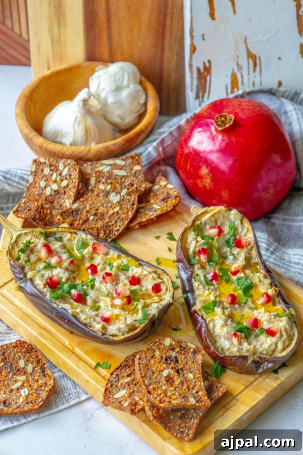 Vibrant Roasted Eggplant with Creamy Tahini and Pomegranate 2 picture of roasted eggplant with tahini and pomegranates and cilantro