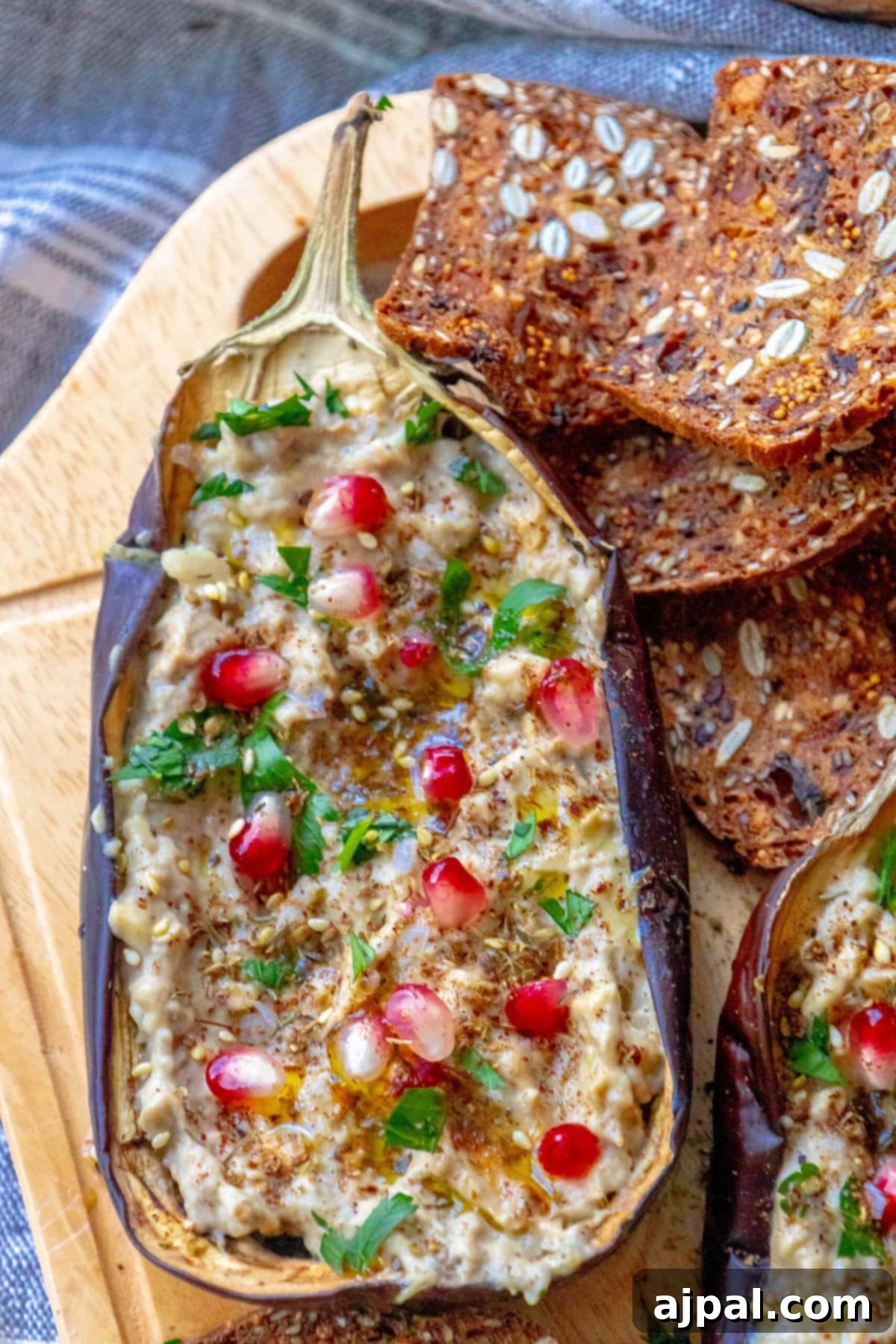 Vibrant Roasted Eggplant with Creamy Tahini and Pomegranate 9 picture of roasted eggplant with tahini and pomegranates and cilantro
