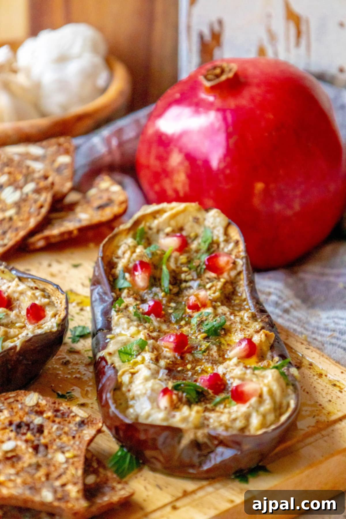 Vibrant Roasted Eggplant with Creamy Tahini and Pomegranate 3 picture of roasted eggplant with tahini and pomegranates and cilantro