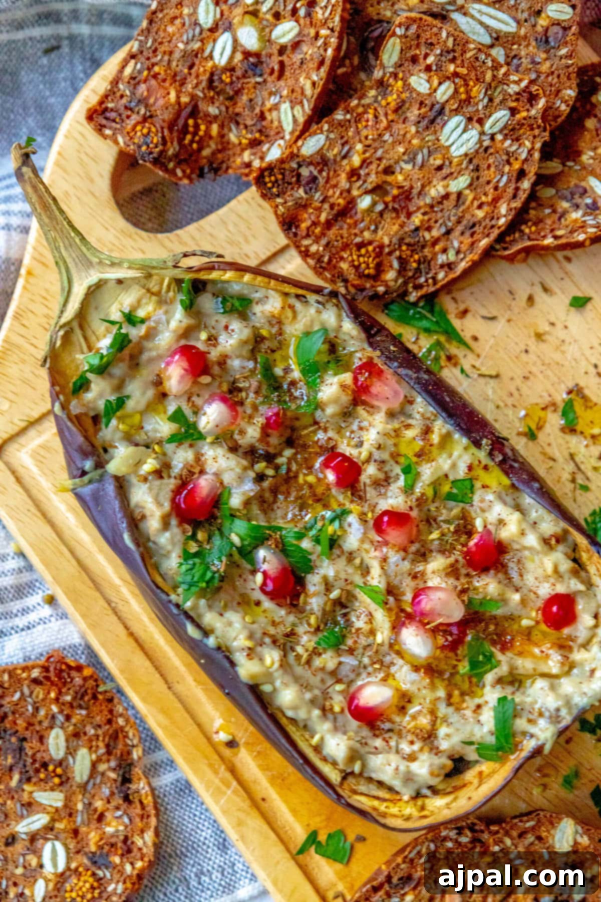 Vibrant Roasted Eggplant with Creamy Tahini and Pomegranate 4 picture of roasted eggplant with tahini and pomegranates and cilantro