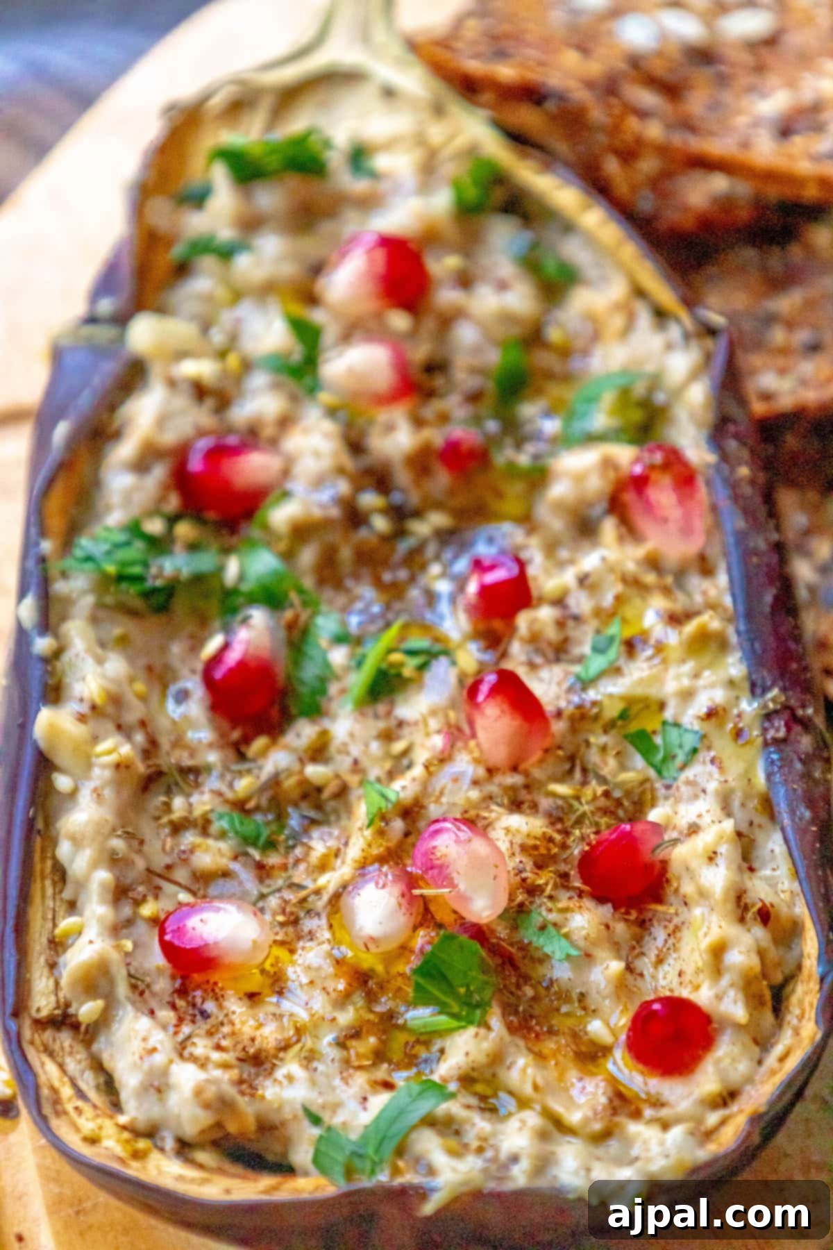 Vibrant Roasted Eggplant with Creamy Tahini and Pomegranate 7 picture of roasted eggplant with tahini and pomegranates and cilantro