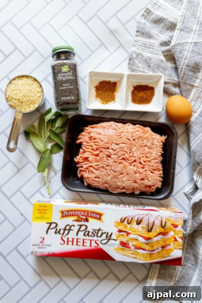 Classic English Sausage Rolls 5 Ingredients for easy sausage rolls neatly arranged on a tiled kitchen counter.