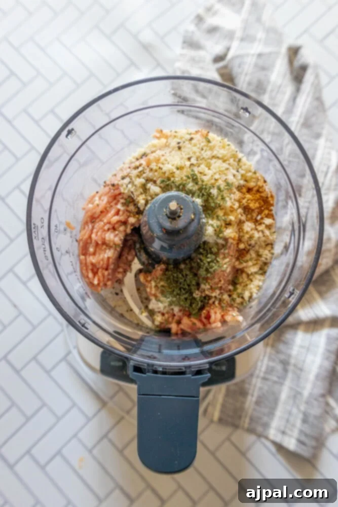 Classic English Sausage Rolls Recipe 6 All ingredients for homemade sausage rolls are placed in a food processor, ready for blending.