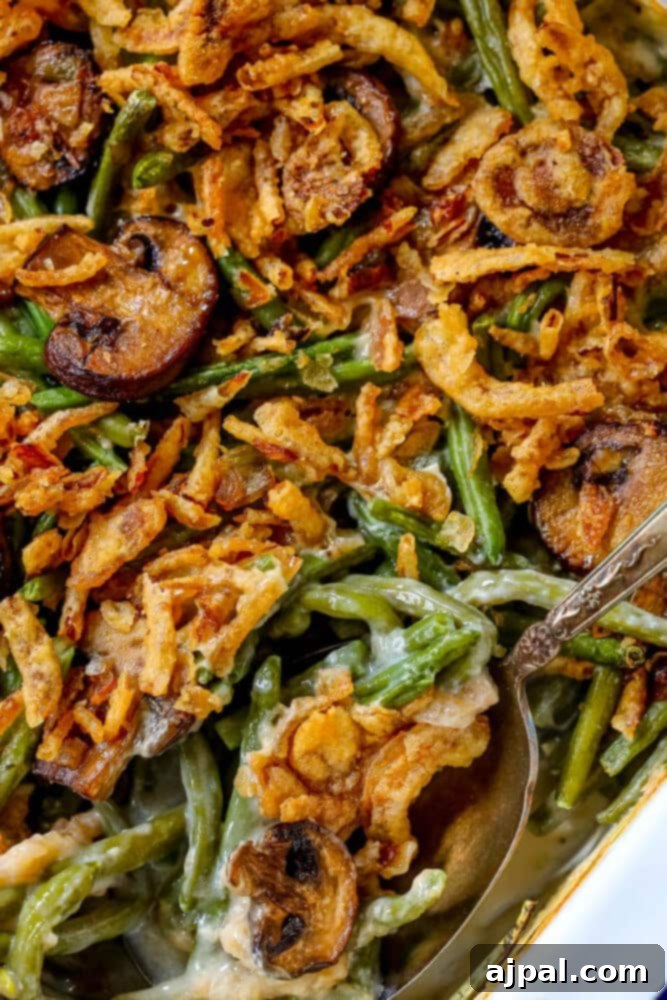 A steaming green bean casserole in a rustic baking dish, with a serving spoon nestled within.
