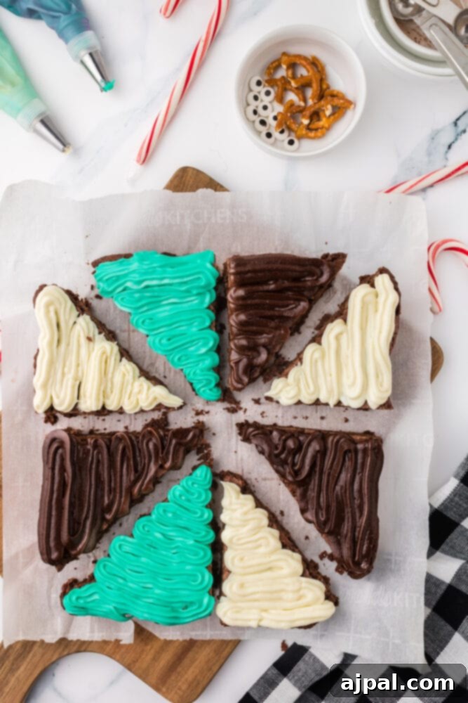 Brownie triangles expertly iced with green, white, and chocolate frosting, awaiting their festive decorations.