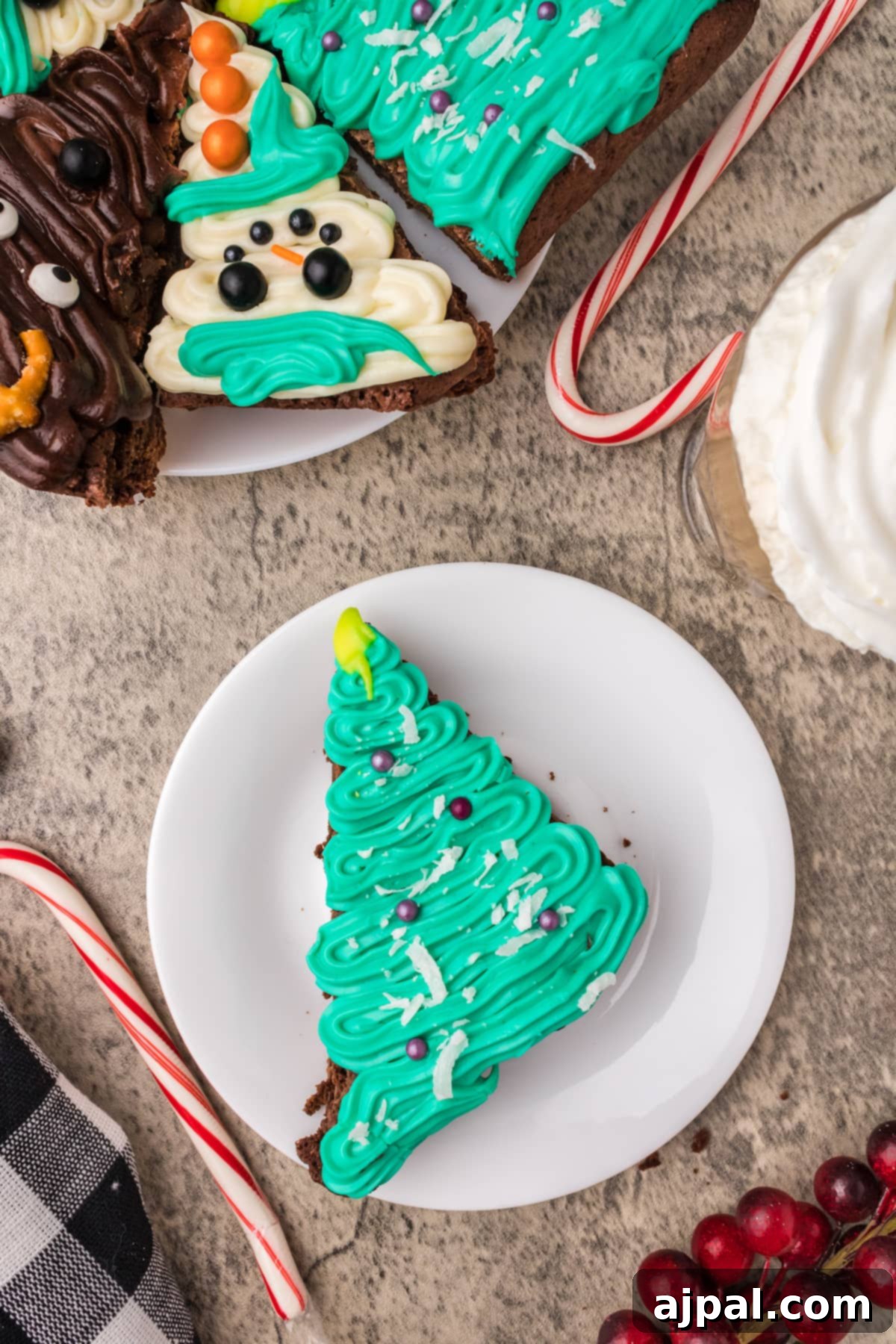 A festive plate showcasing a beautifully frosted Christmas brownie, adorned with intricate icing and a candy cane, ready for the holidays.