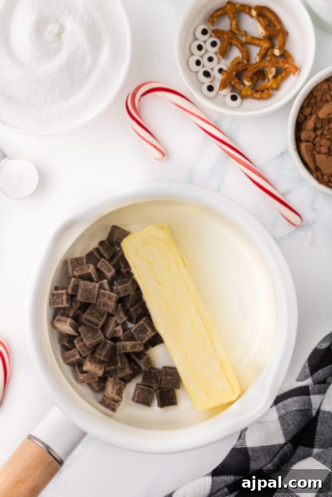 A dish containing butter, chocolate chips, and sugar, melted and ready for mixing into brownie batter.