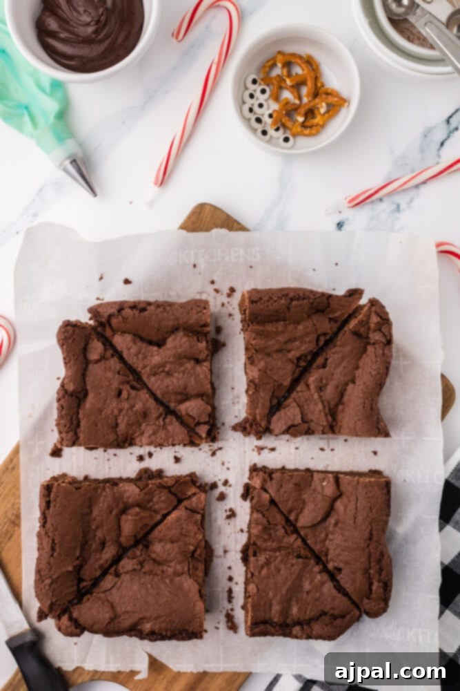 A tray of freshly baked brownies, sliced into neat triangles, ready for frosting and decoration.