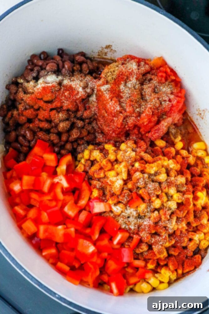 corn, beans, ro-tel, tomatoes, herbs, spices in a pan