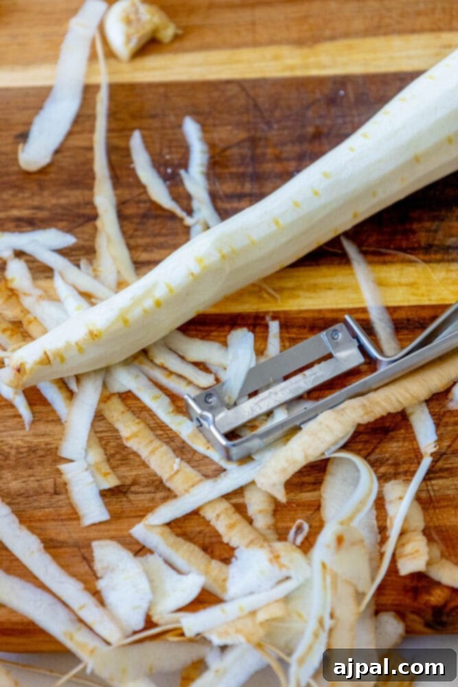 parsnips being peeled on a cutting board