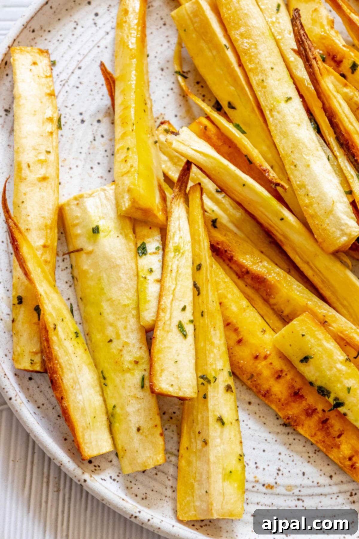 roasted parsnips seasoned with garlic butter and herbs with salt and pepper