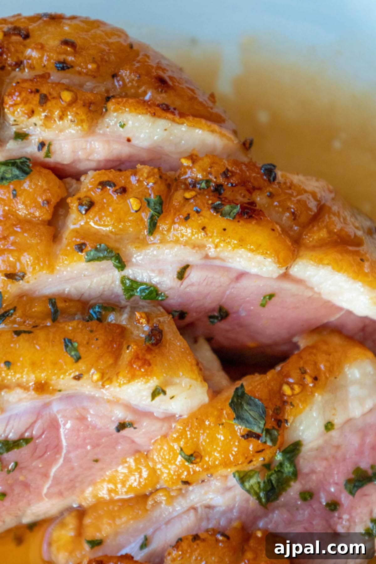 Golden-Crisp Duck Breast with Zesty Orange Reduction 9 Seared duck breast, glistening with orange sauce, elegantly presented on a white plate, ready to be enjoyed as a gourmet meal.