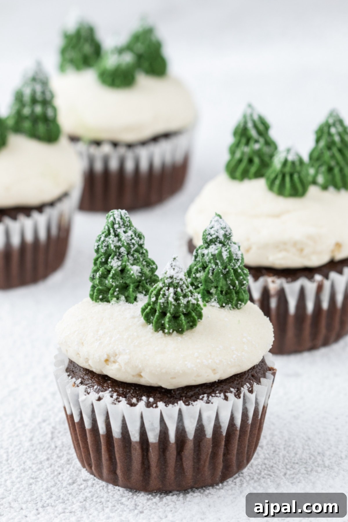 A delicious chocolate winter mint chip cupcake with pristine white icing, a perfect treat for the holiday season.